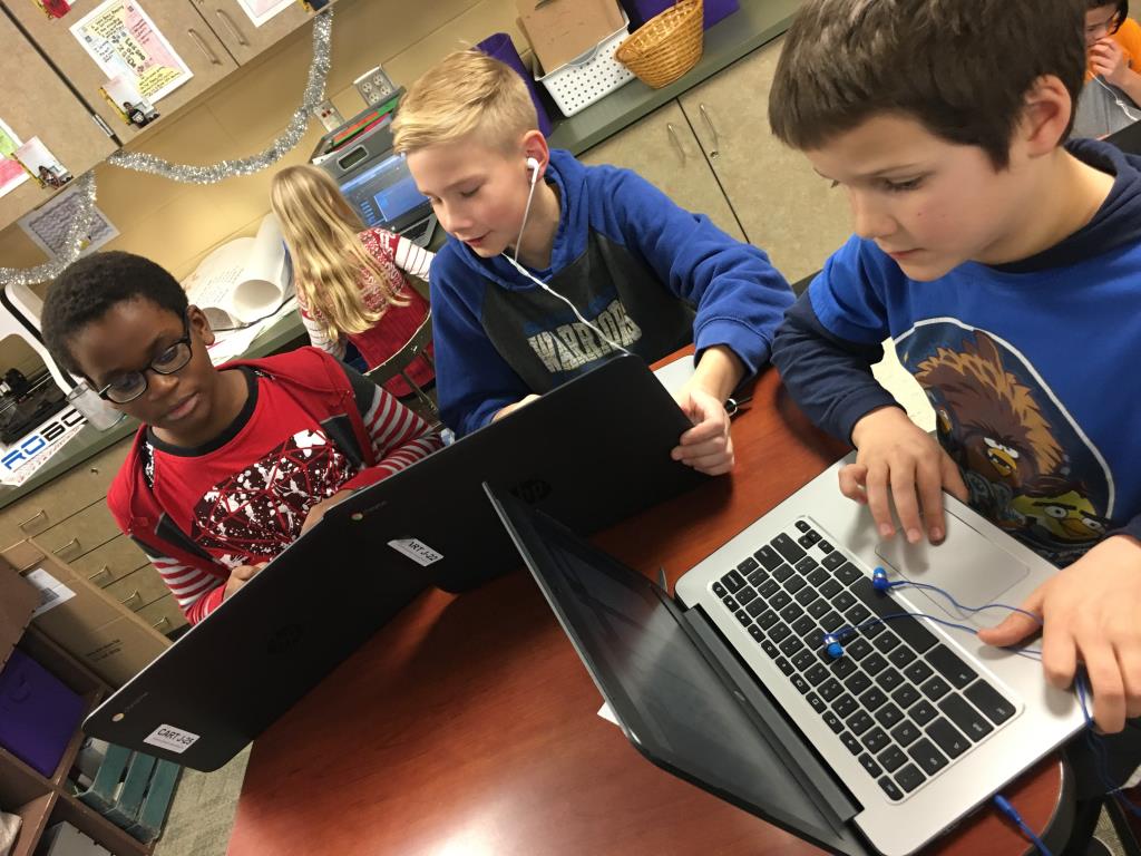 Students collaborating on Chromebooks