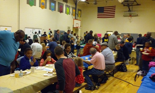 There are a lot of people gathered in the gym for breakfast! 