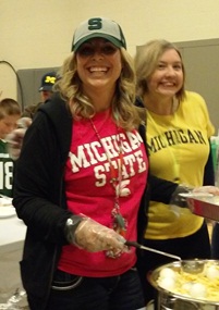 A few of the teachers are smiling while helping with breakfast!