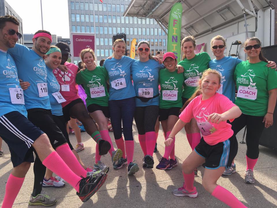 Staff and a student, show off their pink socks!