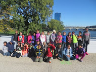 A group of Brookwood Students stand, and kneel, on a bridge with the river to their back. Looking good bobcats!